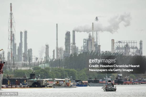 Skimmers work on taking petrochemical products and contaminants out of the water as clean up continues along the Houston Ship Channel in the...