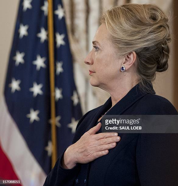 Secretary of State Hillary Clinton stands during the National Anthem prior to speaking at the Gays and Lesbians in Foreign Affairs 20th Anniversary...