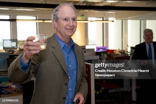 Steve Riley, left, raises a glass as he speaks to the newsroom after he was named the Houston Chronicle's new executive editor on Thursday, May 2 in...