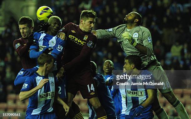 Ali Al Habsi and Jean Beausejour of Wigan battle with Javi Garcia and Matija Nastasic of Manchester City during the Barclays Premier League match...