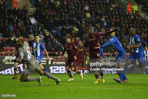 Mario Balotelli of Manchester City scores his sides opening goal during the Barclays Premier League match between Wigan Athletic and Manchester City...