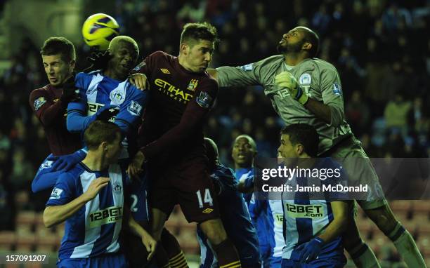 Ali Al Habsi and Jean Beausejour of Wigan battle with Javi Garcia and Matija Nastasic of Manchester City during the Barclays Premier League match...