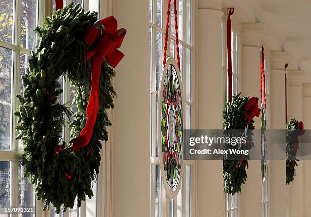 Stained glass window, created by Chicago-based artist David Lee Csicsko, is on display at the East Wing with Christmas wreaths during a preview of...