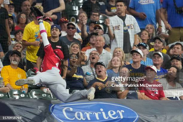 Elly De La Cruz of the Cincinnati Reds is unable to catch a foul ball hit by Victor Caratini of the Milwaukee Brewers in the seventh inning at...