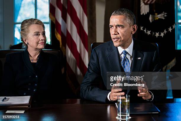 Hillary Clinton, U.S. Secretary of state, left, listens while President Barack Obama speaks during a cabinet meeting at the White House in...