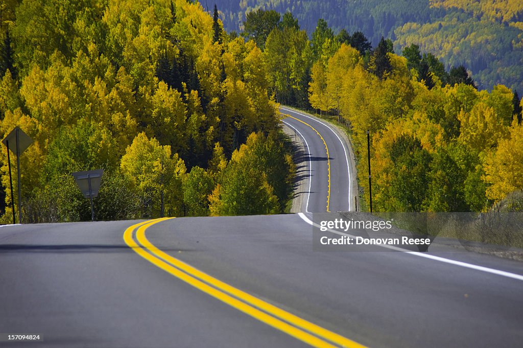 Curving highway through fall foliage