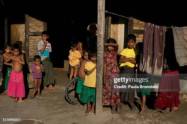 Rohingya refugees stand at a crowded internally displaced persons camp located at a school November 24, 2012 on the outskirts of Sittwe, Myanmar. An...