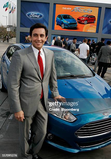 Mark Fields, incoming chief operating officer of Ford Motor Co., stands for a photograph with the Fiesta ST hatchback vehicle during the LA Auto Show...