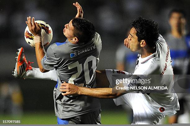 Rhodolfo of Brazil’s Sao Paulo, vies for the ball with Kevin Harbottle of Chile’s Universidad Catolica, during their 2012 Copa Sudamericana semifinal...