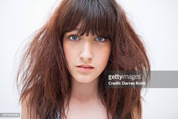 portrait of a young woman with messy hair - bad hair fotografías e imágenes de stock