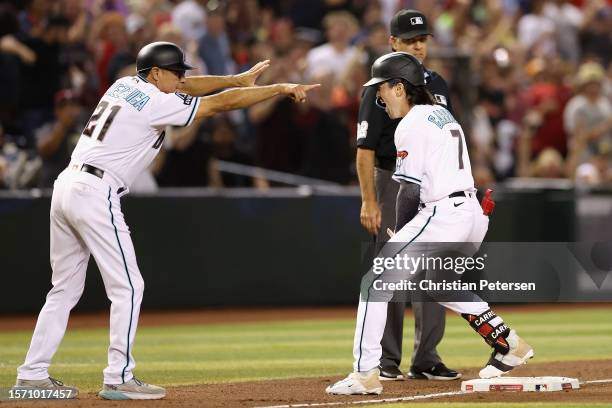 Corbin Carroll of the Arizona Diamondbacks reacts after hitting a two-RBI triple against the St. Louis Cardinals during the eighth inning of the MLB...