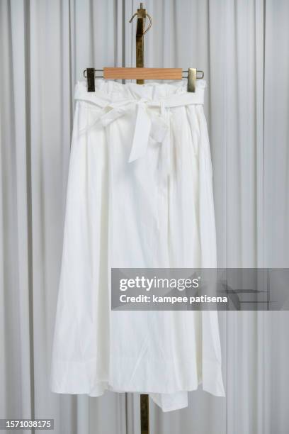 elegant white skirt with front bow | chic fashion apparel on hanger - white skirt stock pictures, royalty-free photos & images