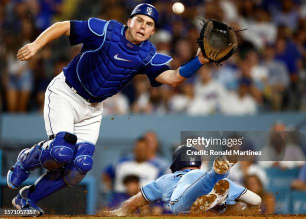 Matt Chapman of the Toronto Blue Jays slides for a run past Will Smith of the Los Angeles Dodgers in the eighth inning at Dodger Stadium on July 25,...