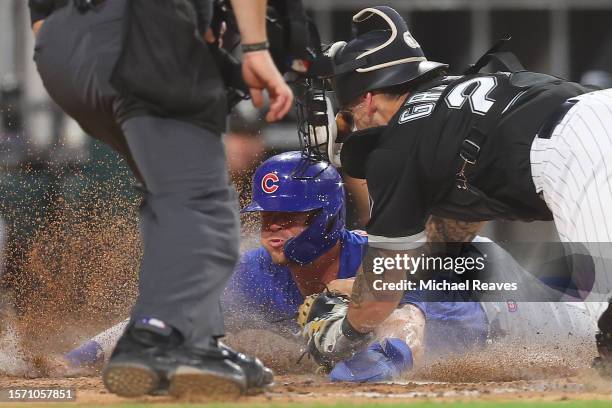 Nico Hoerner of the Chicago Cubs safely scores a run past the tag of Yasmani Grandal of the Chicago White Sox during the sixth inning at Guaranteed...