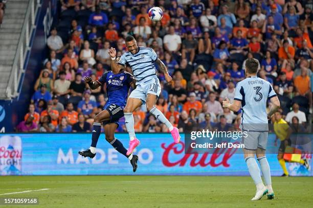 Khiry Shelton of Sporting Kansas City heads the ball against Alvas Powell of FC Cincinnati during the second half of a Leagues Cup match at TQL...
