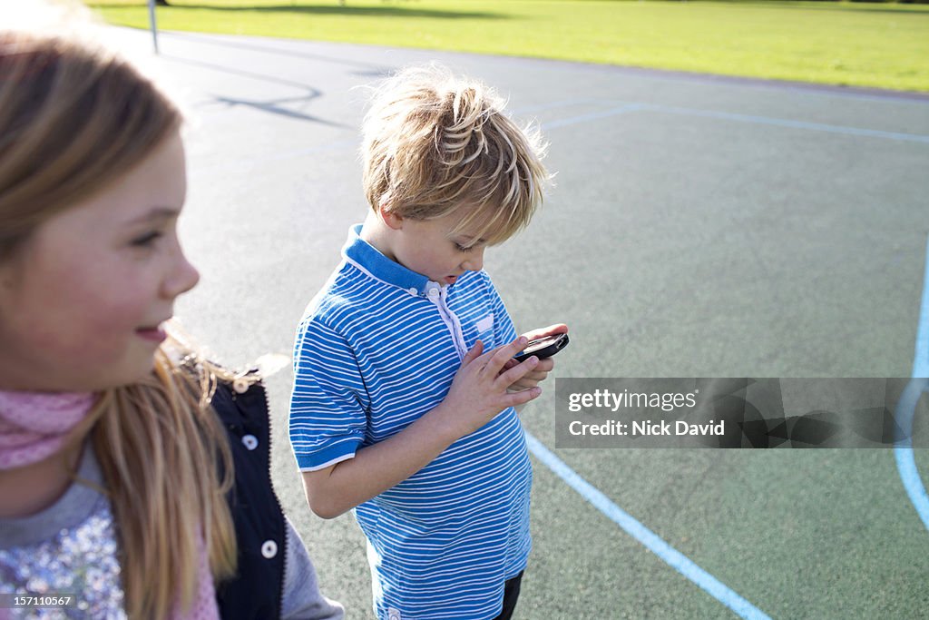 Children playing on a mobile phone