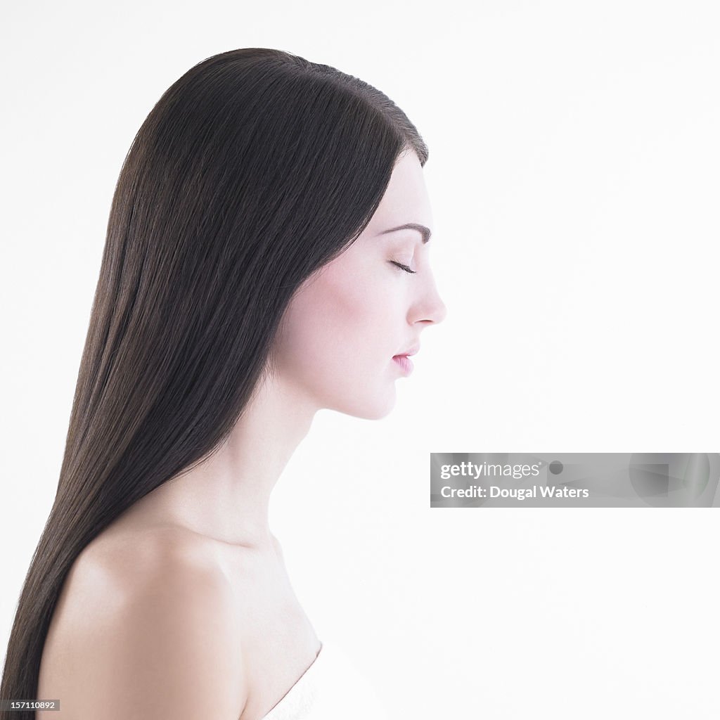 Profile of woman with eyes closed.