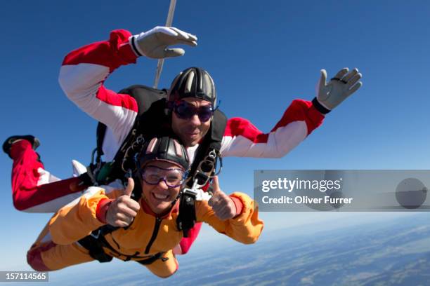 skydive tandem passenger having a great time - skydive stock pictures, royalty-free photos & images