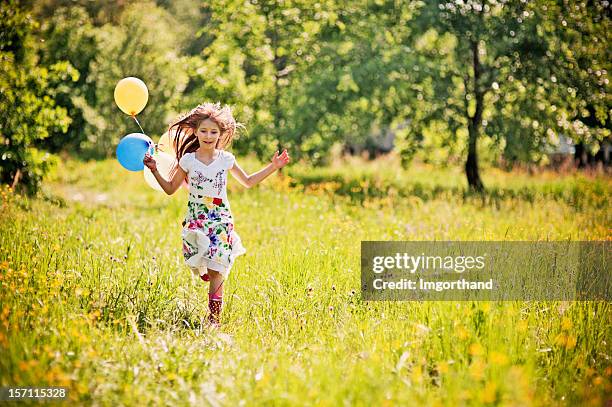 little girl running with balloons - saturated color stock pictures, royalty-free photos & images