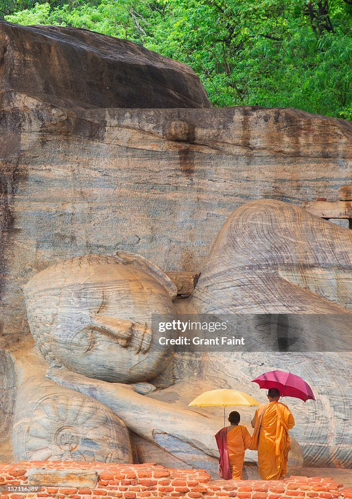 Monks by huge buddha.