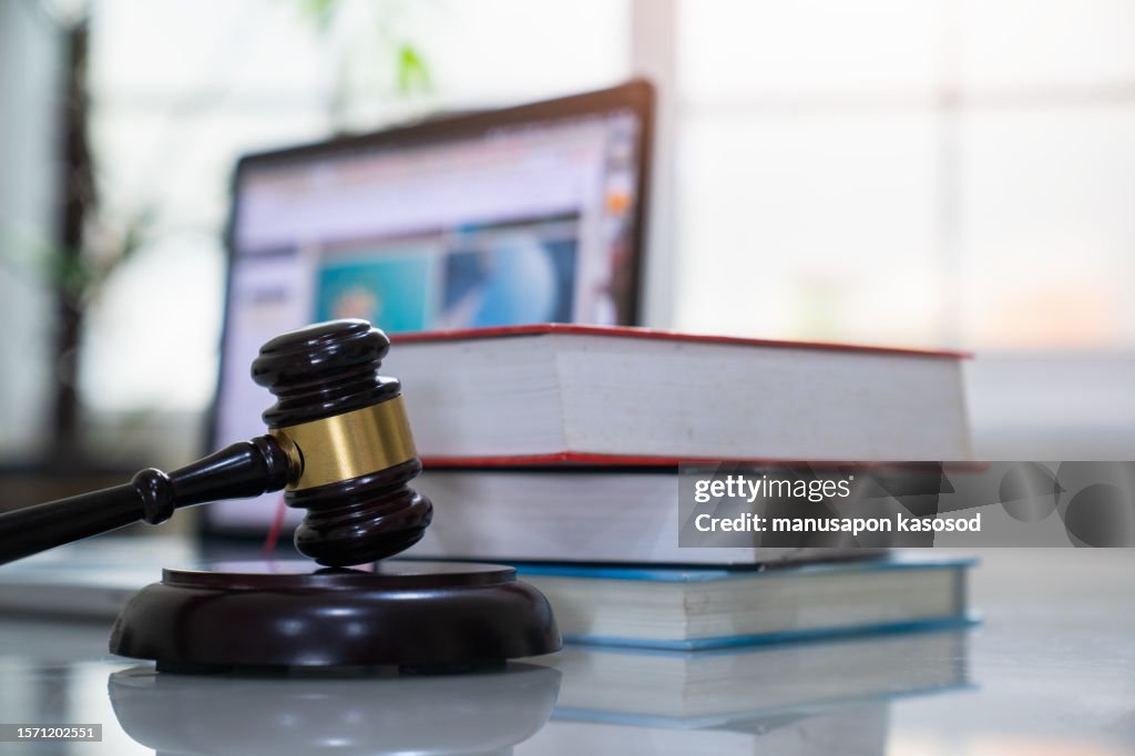 Judge gavel and legal book on wooden table, justice and law concept