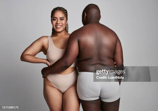 hug, plus size and portrait of couple in studio in underwear for wellness, health and skincare. natural, beauty and back of man and woman embrace on gray background for body positivity, care or love - body positive stock pictures, royalty-free photos & images