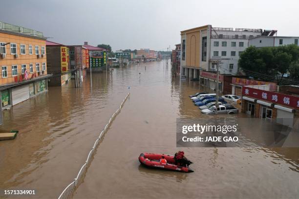 This aerial view shows a flooded village after heavy rains in Zhuozhou, Baoding city, in northern China's Hebei province on August 2, 2023.