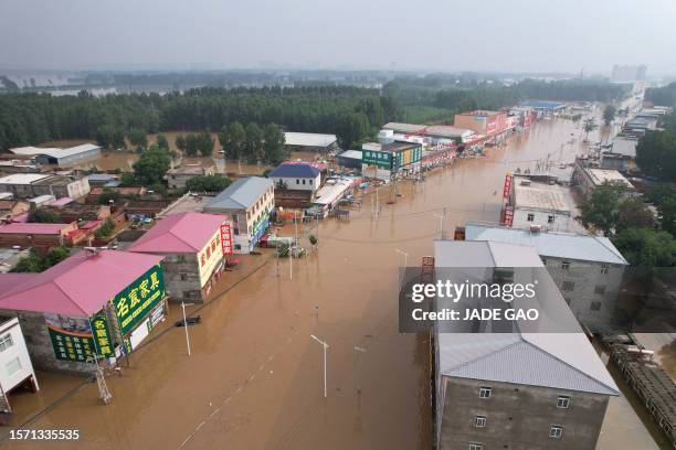 This aerial view shows a flooded village after heavy rains in Zhuozhou, Baoding city, in northern China's Hebei province on August 2, 2023.