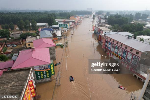 This aerial view shows a flooded village after heavy rains in Zhuozhou, Baoding city, in northern China's Hebei province on August 2, 2023.