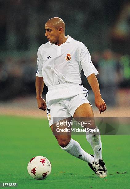 Roberto Carlos of Real Madrid runs with the ball during the UEFA Champions League Group A match against AS Roma played at the Stadio Olimpico, in...