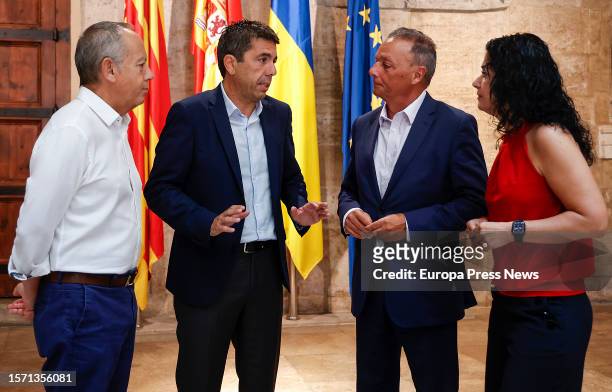 The president of the Generalitat, Carlos Mazon , talks upon his arrival at a meeting with the president of CEV, Salvador Navarro ; the general...