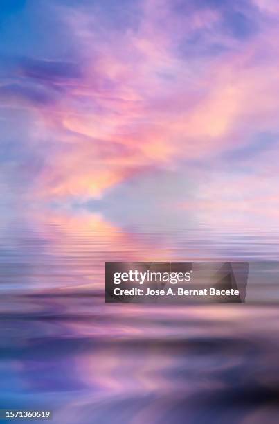 sunset over a water surface with waves. - hot summer nights film stock-fotos und bilder