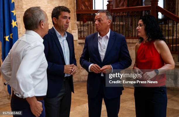 The president of the Generalitat, Carlos Mazon , talks upon his arrival at a meeting with the president of CEV, Salvador Navarro ; the general...