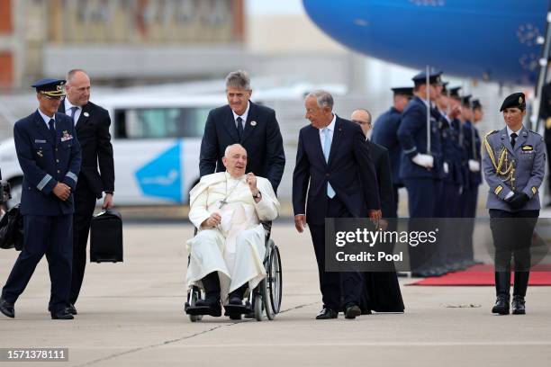 Pope Francis is welcomed by Portugal's President Marcelo Rebelo de Sousa upon his arrival at Figo Maduro airbase on August 2, 2023 in Lisbon,...