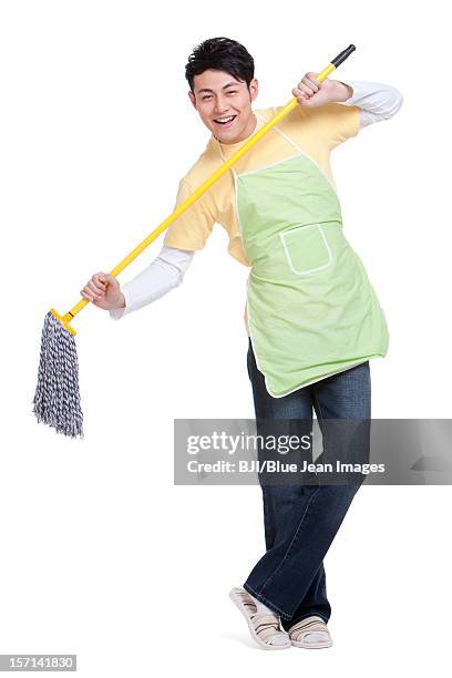 happy housework time - apron isolated stockfoto's en -beelden