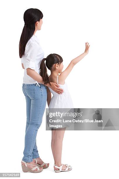 mother and daughter waving to the front - girl from behind stock pictures, royalty-free photos & images