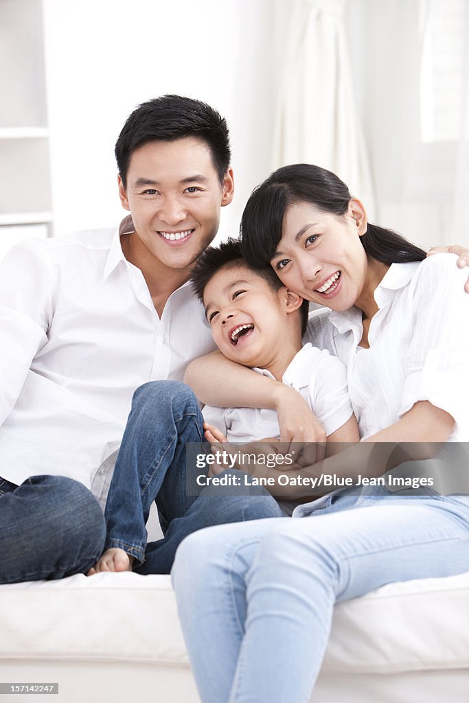 Happy family sitting in sofa