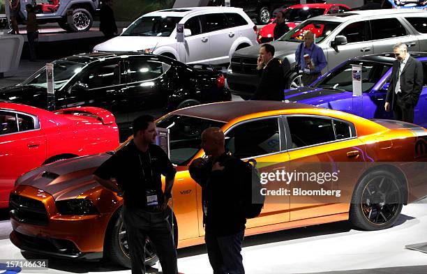 Automobiles stand on display on the floor of the LA Auto Show in Los Angeles, California, U.S., on Wednesday, Nov. 28, 2012. The LA Auto Show is open...