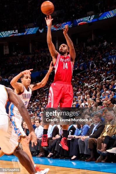 Daequan Cook of the Houston Rockets shoots a three-pointer against ...