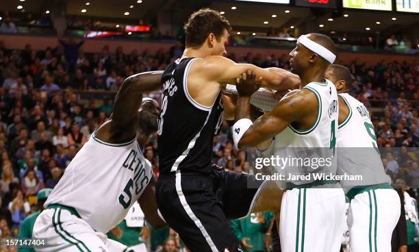 Kevin Garnett, Jason Terry, and Rajon Rondo of the Boston Celtics get into a fight with Kris Humphries of the Brooklyn Nets during the game after...