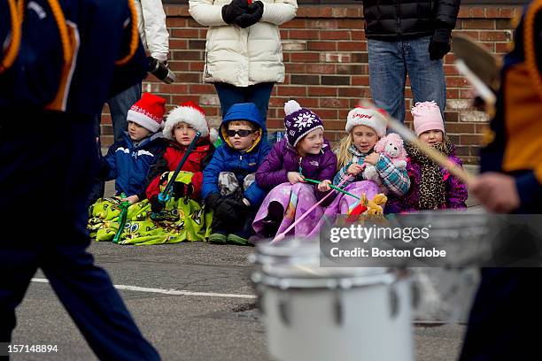 From left, cousins, Michael Riley Brendan Riley Tommy Regan Dianna Regan Mary Riley and Olivia Farrow sit and enjoy the Annual Christmas Parade in...