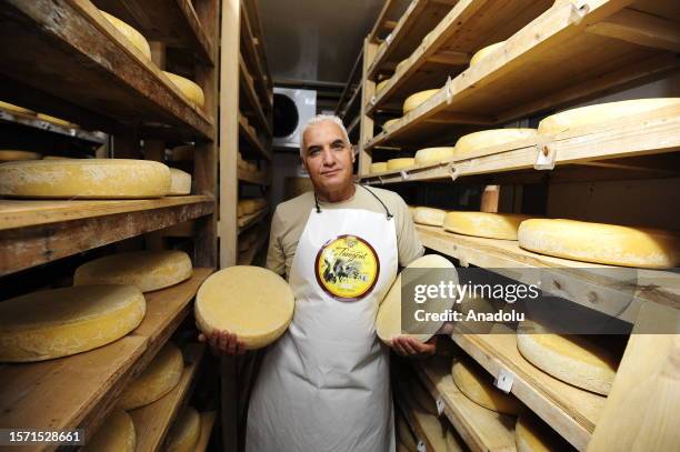 Rashid Ibersian shows the cheeses he produces in his own facility at the town of Feriha in Tizi Ouzou, Algeria on July 20, 2023. While working in the...