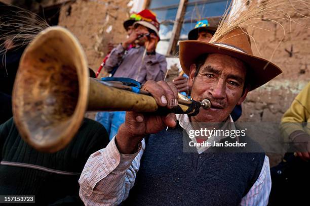 Peruvian peasant plays a trumpet during the Yawar Fiesta, a ritual fight between the condor and the bull, held in the mountains of Apurímac on 30...