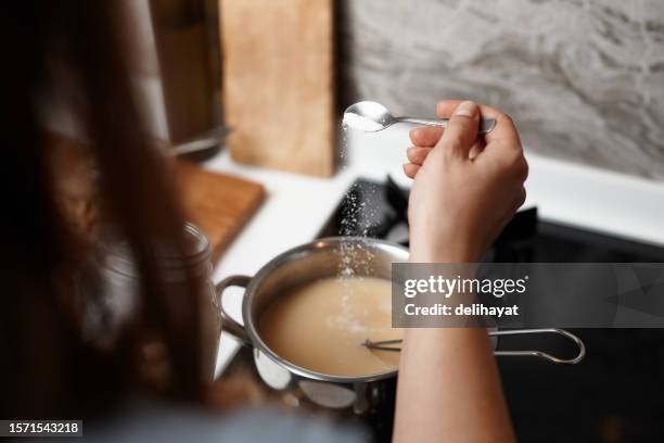 adding salt to the soup - sprinkling stock pictures, royalty-free photos & images