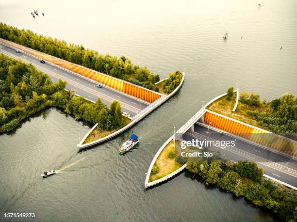 aquaduct veluwemeer in the veluwe lake with a boat sailing in the canal - aqueduct stock pictures, royalty-free photos & images