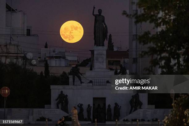 Sturgeon supermoon rises behind the Liberty Monument in Nicosia on August 1, 2023.