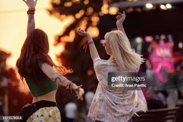 dancing on a music festival at sunset! - touring music festival stock pictures, royalty-free photos & images