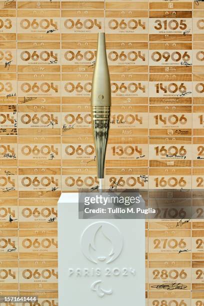 The Olympic Torch is displayed during the IOC Invitationa Ceremony on July 26, 2023 in Paris, France. Paris will host the Summer Olympics from July...