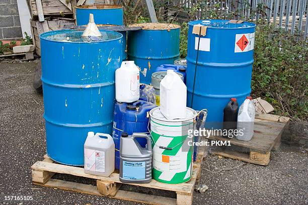 industrial waste stored outside atop wooden pallets - poisonous stock pictures, royalty-free photos & images