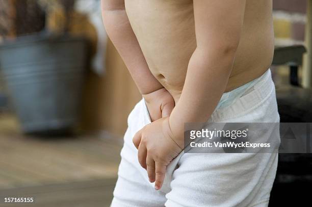 need to pee? - child urinating stockfoto's en -beelden